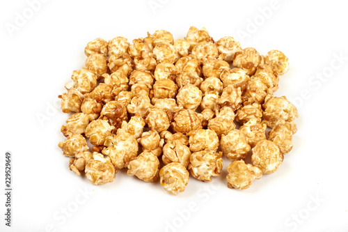 Pile of caramel popcorn on white background.