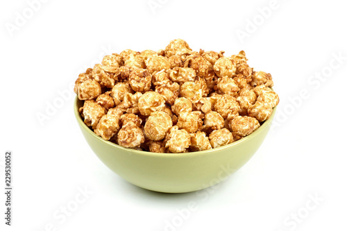 caramel popcorn in a bowl on a white background