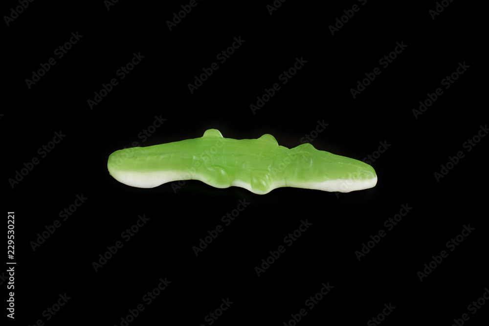 jelly candies in the crocodile shape on a black background. jelly candies in the crocodile shape on a black background.
