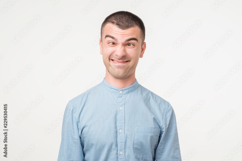 Caucaisan man in blue shirt making silly face. Caucaisan man in blue shirt making silly face.