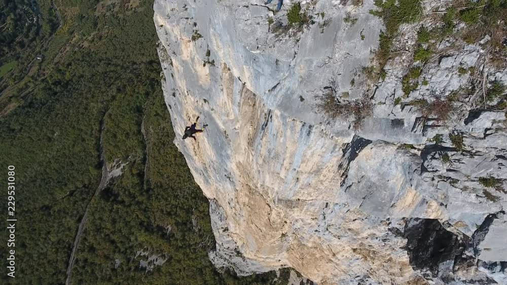 Following by drone a man base jumping from a cliff in Choranche France. Following by drone a man base jumping from a cliff in Choranche France.