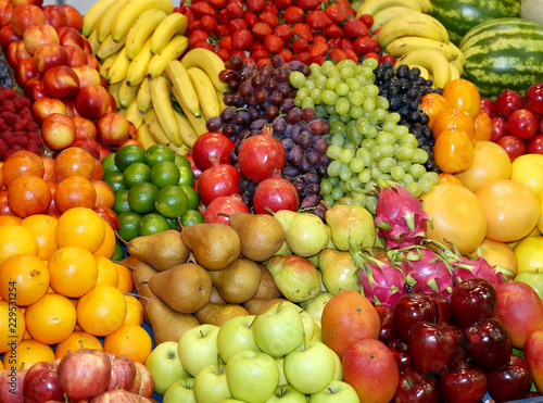 Farmers market with various colorful fresh healthy fruits for sale. A big choice of ripe various fresh fruits  on market