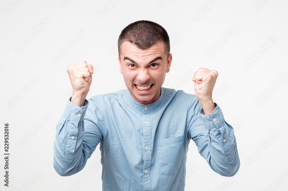 Close up portrait of furious young hispanic man shouting and yelling. Close up portrait of furious young hispanic man shouting and yelling.