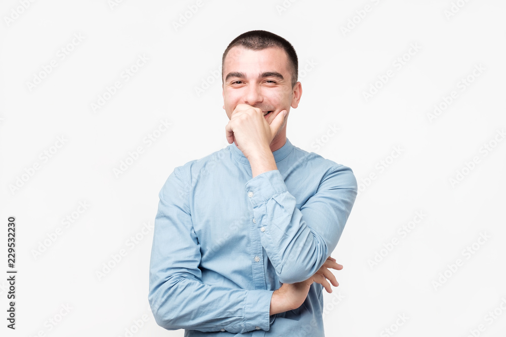 Hispanic young man with laugh face on grey background. Hispanic young man with laugh face on grey background.