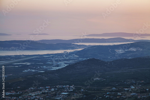 Top view of small city and islands layered with mist after sunset