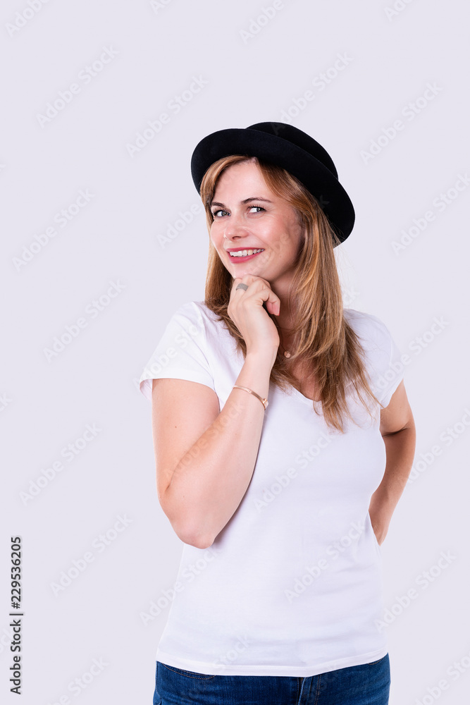 Portrait of smiling woman wearing in a black hat and white t-shirt on white background Portrait of smiling woman wearing in a black hat and white t-shirt on white background