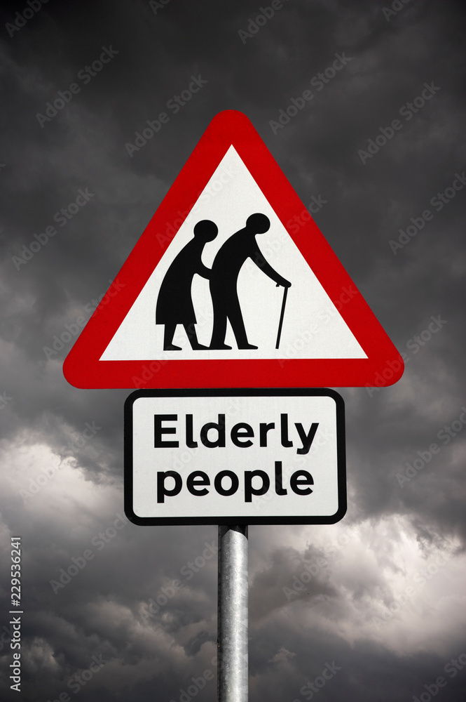 ELEDERLY PEOPLE ROAD TRAFFIC SIGN AGAINST STORMY SKY ELEDERLY PEOPLE ROAD TRAFFIC SIGN AGAINST STORMY SKY
