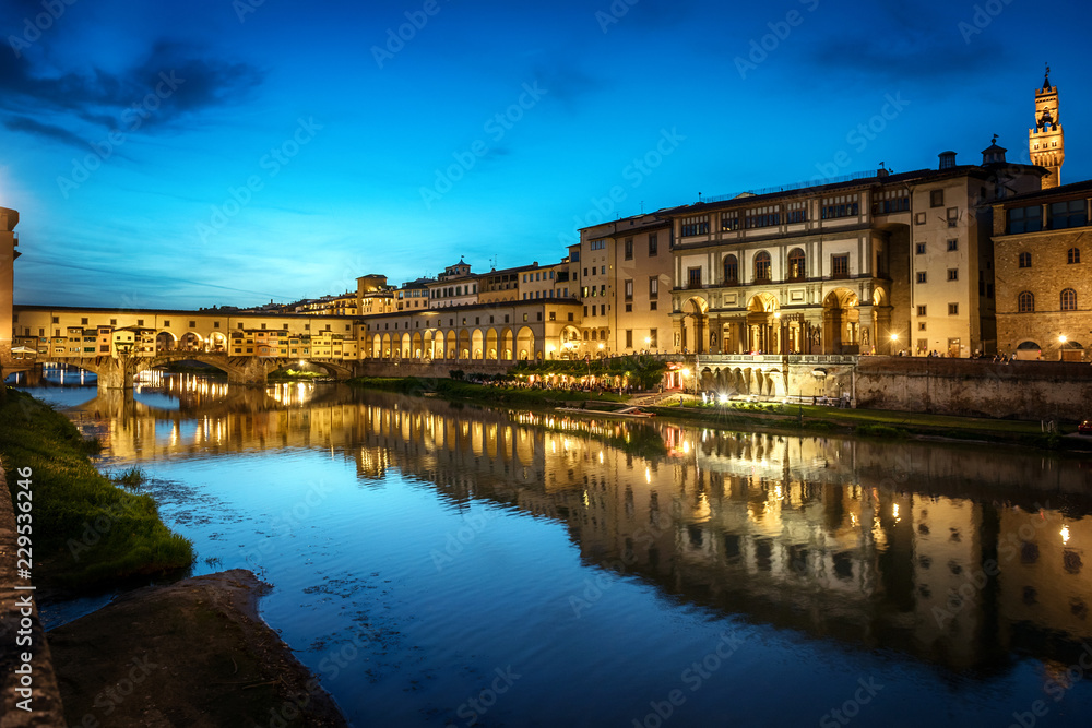 Evening view of the famous bridge Ponte Vecchio and Uffizi Gallery on the river Arno in Florence, Italy.