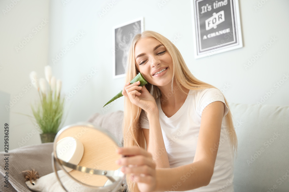 Beautiful young woman using aloe vera at home Beautiful young woman using aloe vera at home