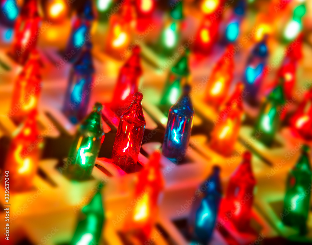 Obraz premium ROW OF DIFFERENT COLOURED CHRISTMAS LIGHTS IN CLOSE UP