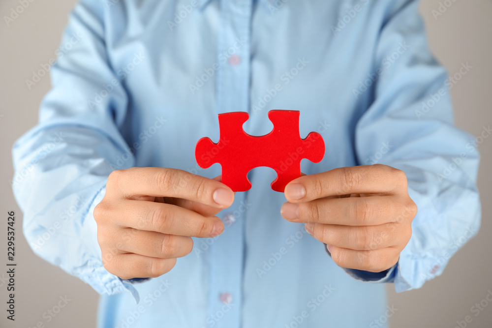 Fototapeta premium Woman with piece of color puzzle, closeup