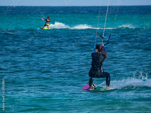 kite surfing, an extreme sport practiced in windy places on a board pulled by a sail