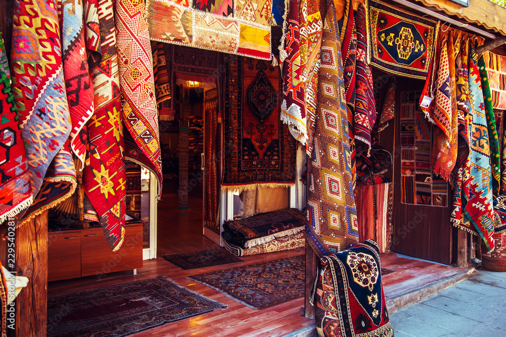 Amazing traditional handmade turkish carpets in souvenir shop. - obrazy, fototapety, plakaty 