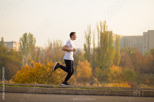 Man run at autumn morning. Healthy lifestyle