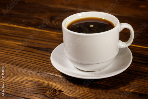 Cup of coffee on the wooden table