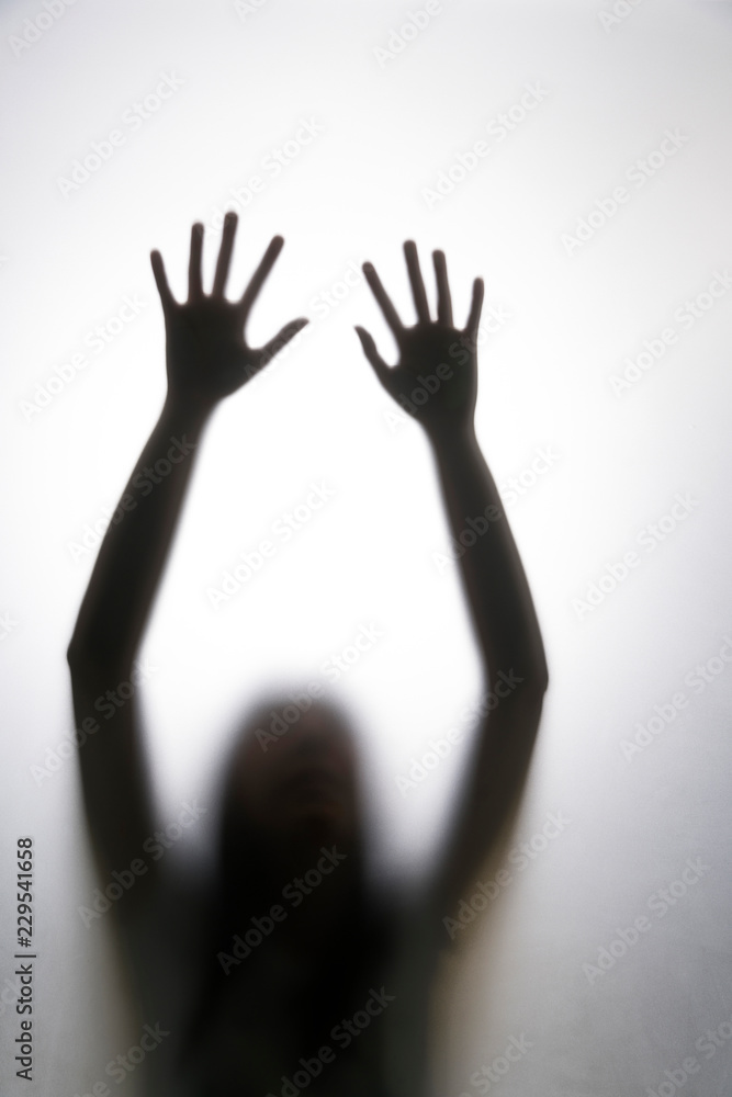 Shadow hands of the woman behind the white curtain Shadow hands of the woman behind the white curtain