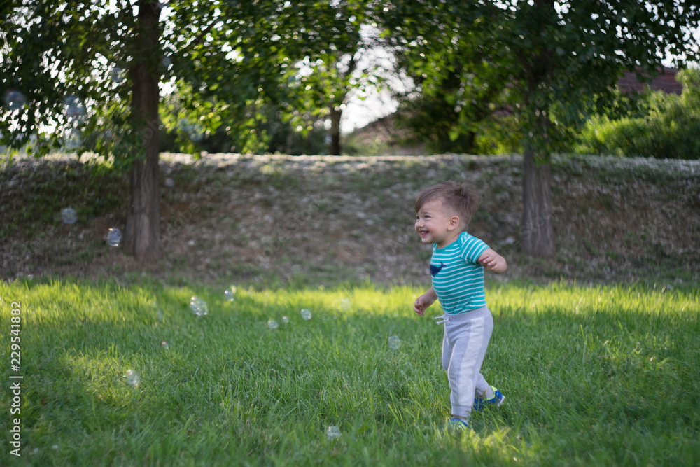 little boy running in the park