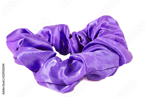 Shiny purple scrunchie for tying hair back, isolated on white background