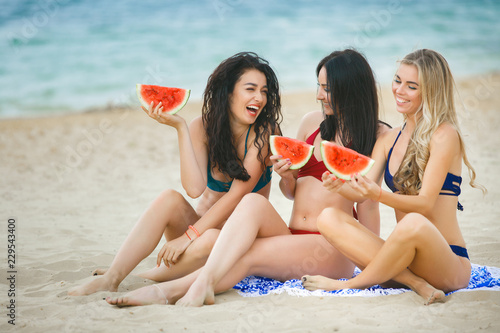 Young attractive women having fun on the beach. Group of beautiful girls in summer