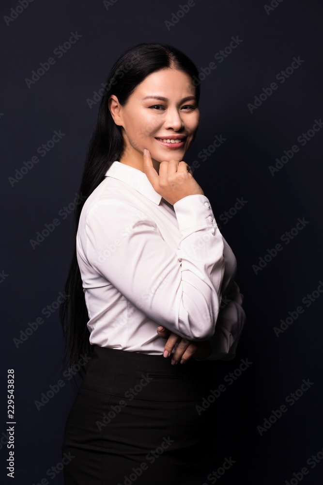 Side view image of beautiful brunette business woman smiling and touching her cheeck. Business concept. Side view image of beautiful brunette business woman smiling and touching her cheeck. Business concept.