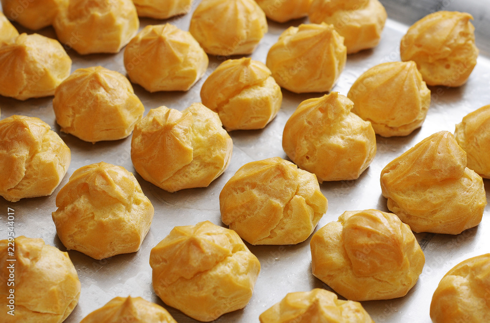 Profiteroles in the oven. Eclair. Homemade Cream Puffs. Profiteroles in the oven. Eclair. Homemade Cream Puffs.