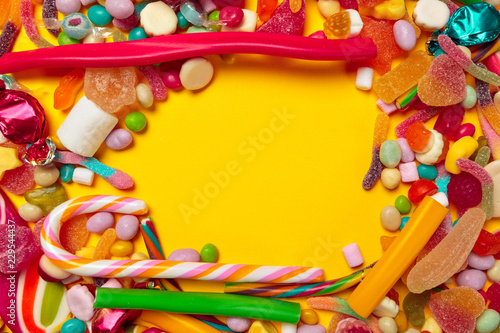 colored candies on yellow background