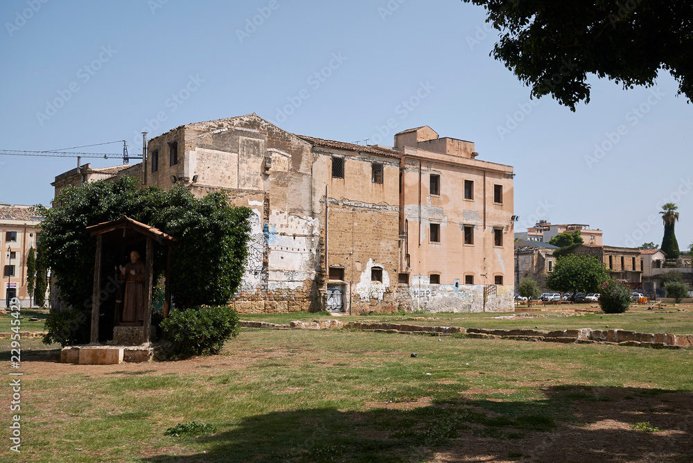 Palermo, Italy - September 06, 2018 : View of Piazza Magione garden and Ex Chiesa e Collegio di S Maria della Sapienza