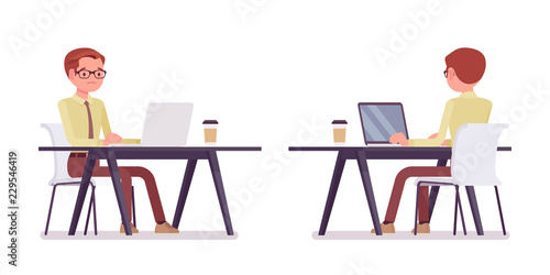Male clerk working with laptop