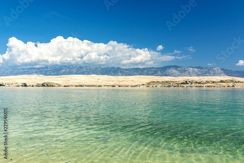 Beautiful beach, blue water, mountains in the background