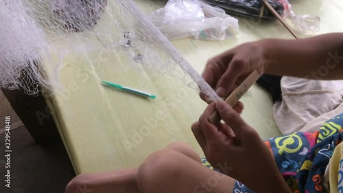 Weaving fishnet for catching fish.