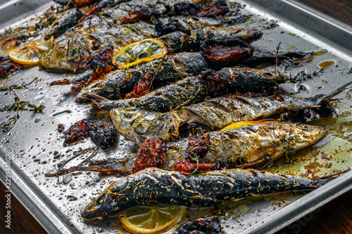 Delicious baked sardines on a tray. Healthy meal made of fresh fish. photo