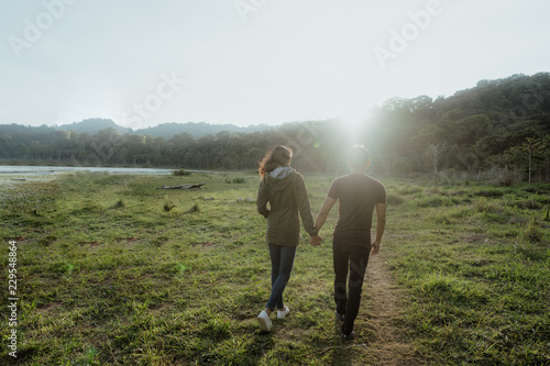 happy young asian couple in countryside enjoying nature © Odua Images