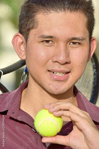 Athletic Minority Tennis Player Smiling With Tennis Racket © dtiberio