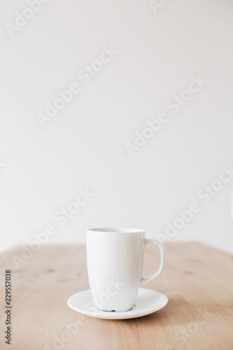 Cup of coffee on clean wooden table. Flat lay, top view.