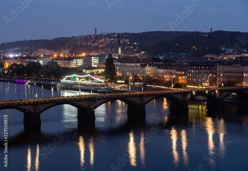 view from the top of the dancing house down to the bridge over the Vltava in Prague at night - Czech Republic