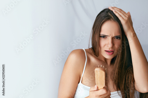 Hair Loss. Upset Woman Holding Brush With Hair