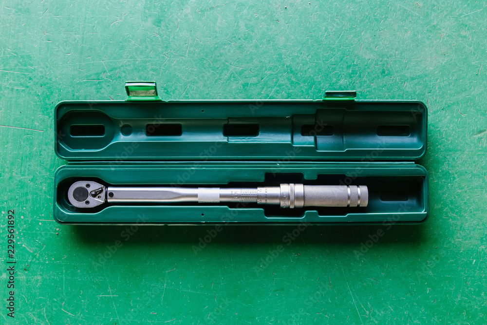 Professional toolbox with modern tools at garage on green backgrounds Professional toolbox with modern tools at garage on green backgrounds