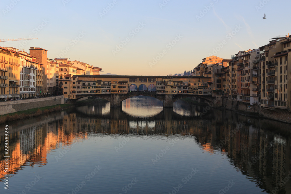Sunset view of Ponte Vecchio over Arno River in Florence, Italy. 