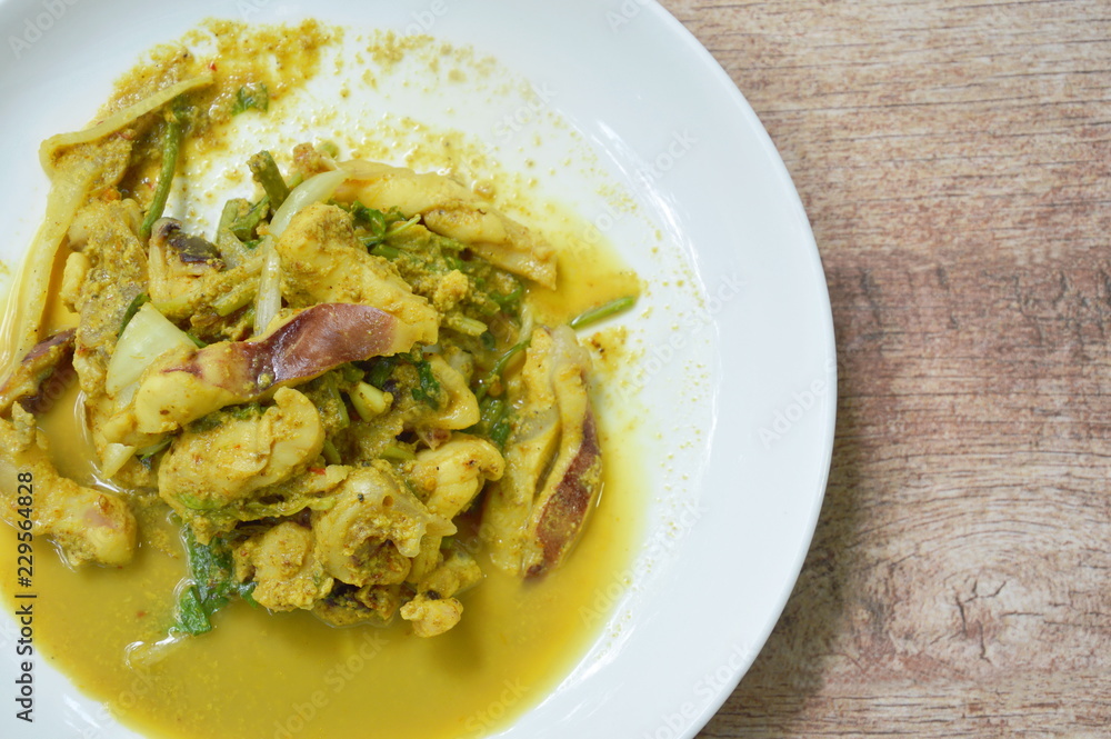 stir fried squid with yellow curry on plate