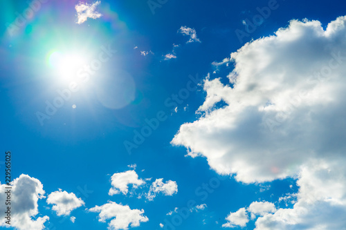 Photo of blue sky with bright sun.