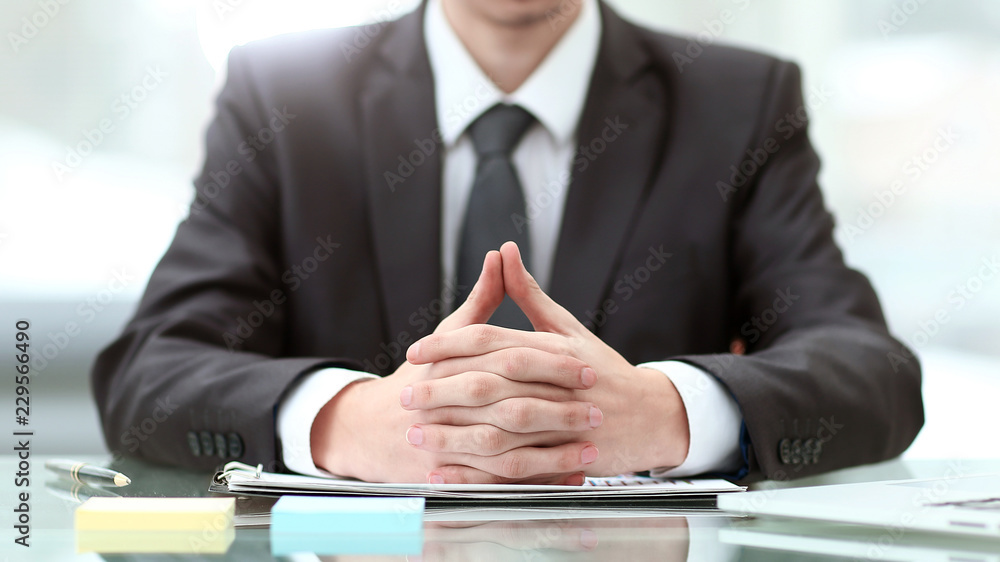 close up. young businessman sitting at Desk close up. young businessman sitting at Desk