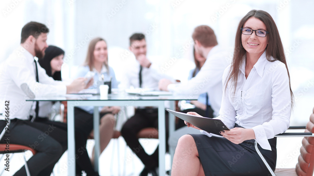 business woman signing a business document with its background blurred office business woman signing a business document with its background blurred office