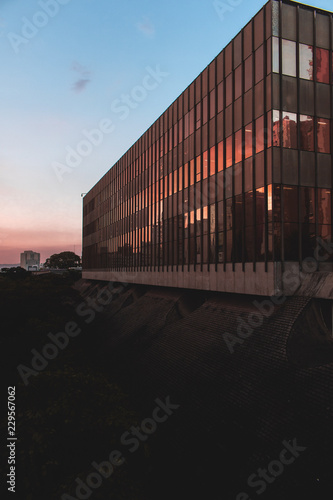 glass building reflecting the sunset