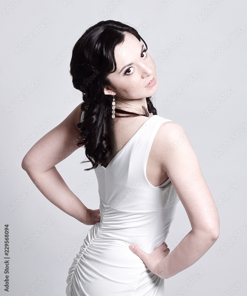 Fototapeta premium young woman model in white evening dress posing
