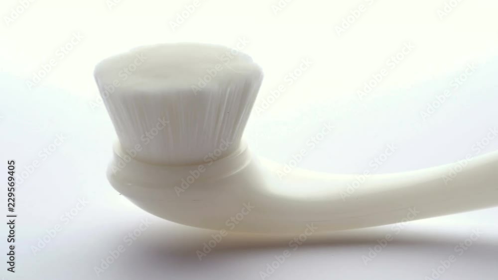dolly shot Scrub brush made of white plastic on white background. dolly shot Scrub brush made of white plastic on white background.