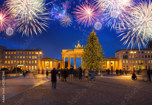 Bradenburg Gate with Christmas tree illuminated at night with fireworks, Berlin Germany