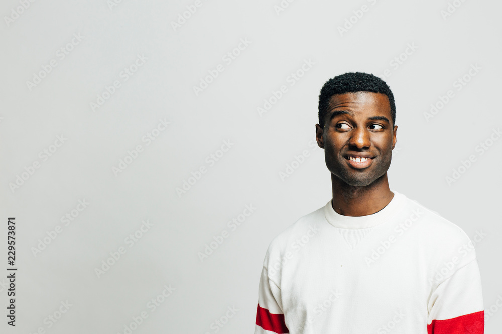 Portrait of a casual young man looking left, isolated on white studio background Portrait of a casual young man looking left, isolated on white studio background