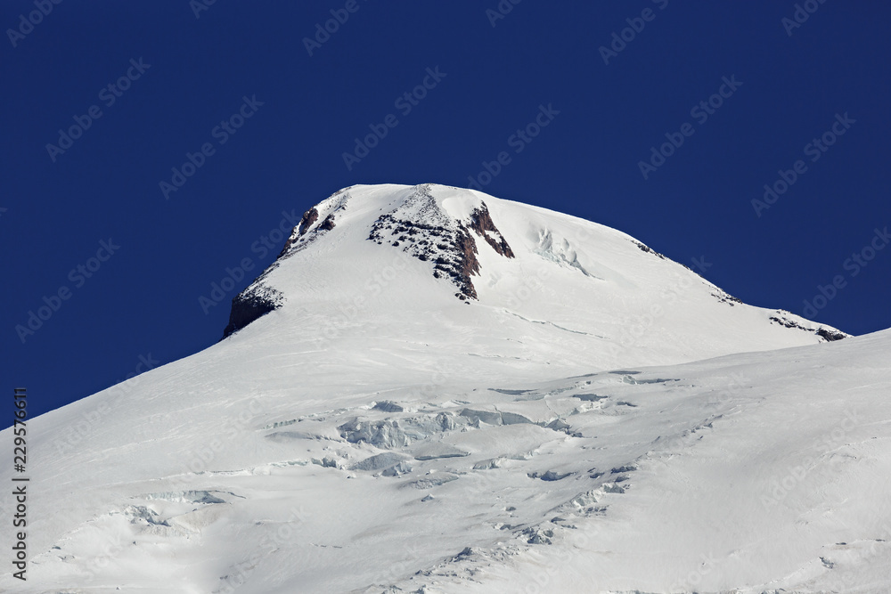 Close-up of the snow-covered western peak of Mount Elbrus in the North Caucasus in Russia.