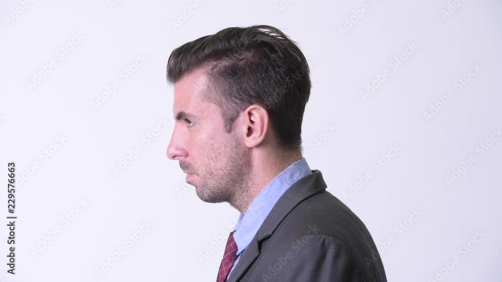 Profile view of young handsome Hispanic businessman looking up Profile view of young handsome Hispanic businessman looking up