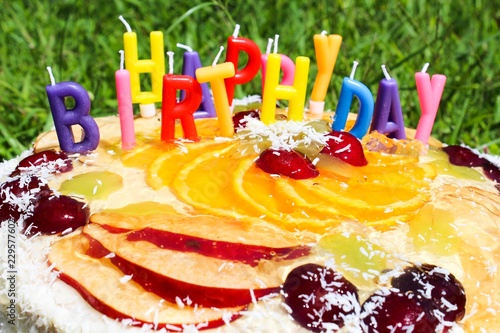 Birthday cake decorated by colorful candles 